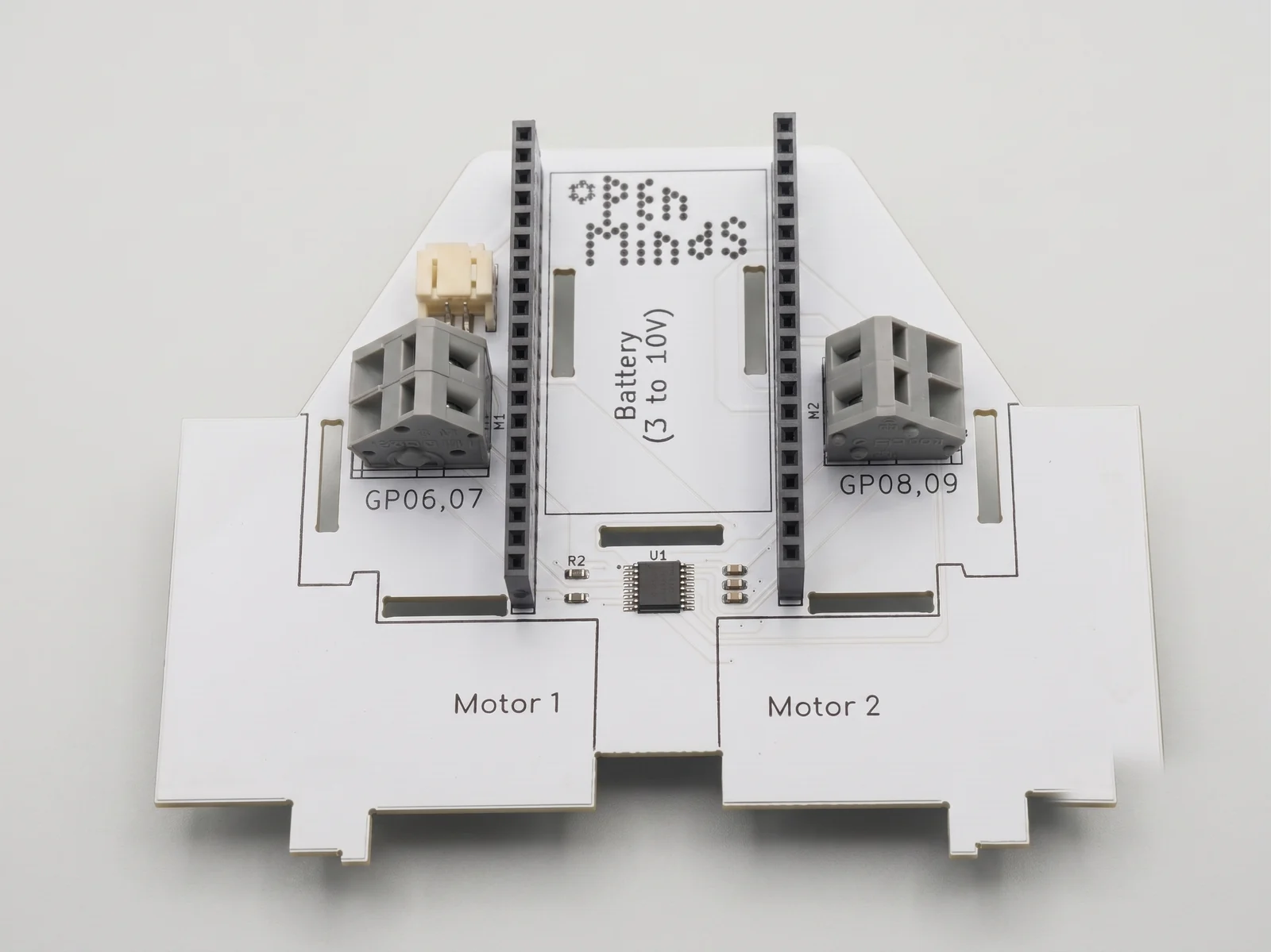 The Motor hat seen from above, with two grey screw-terminal blocks for Motor 1 and Motor 2 and the battery input.
