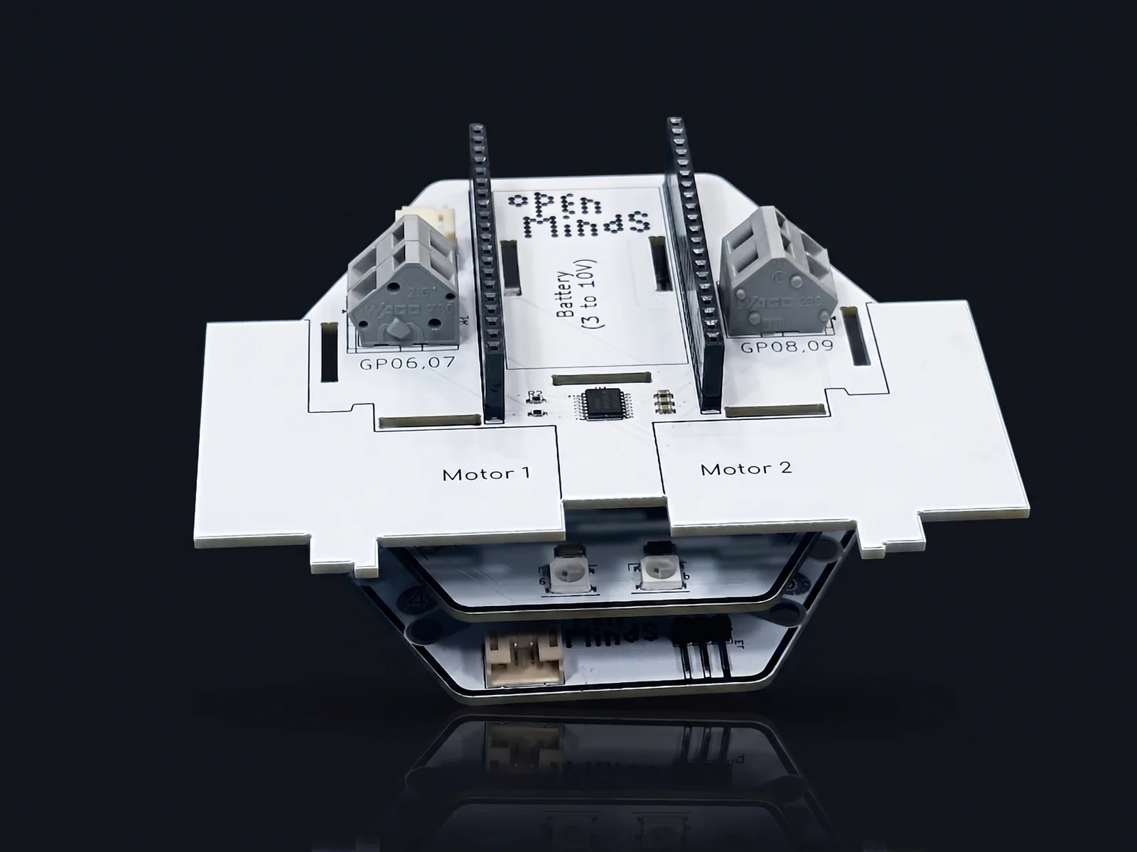 The Motor Driver hat stacked on the main board, its two screw-terminal outputs labelled Motor 1 and Motor 2, on a dark studio background.